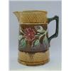 Image 1 : A MAJOLICA PITCHER, c.1880, moulded band of briar roses, branch handle, pink interior, height 20c