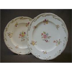 A PAIR OF COALPORT CABINET PLATES, 19th Century, transferred and over-painted flower sprays on a