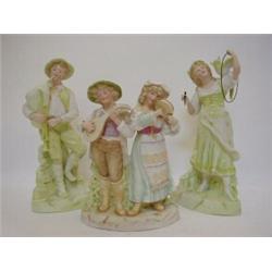 A TINTED BISQUE TRIO, c.1890, young boy with Chalumeau, girl with Cockatoo and hoop and a pair on