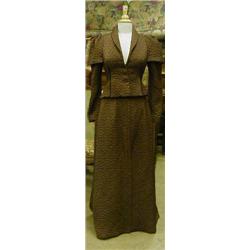 A late Edwardian style chocolate brown quilted jacket and full skirt outfit with full size dummy.
