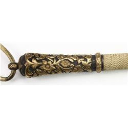 Finely braided quirt with high relief gold floral