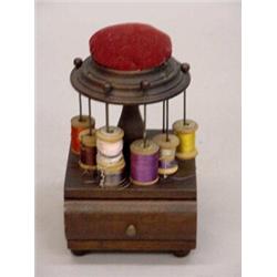 SMALL WOODEN SEWING CADDY. Walnut with original finish. Red velvet pincushion top. Small rods for…