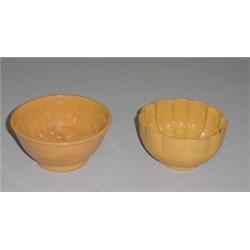 TWO YELLOWWARE FOOD MOLDS. One is circular with scalloping and signed "Mogana". 6 1/8"d. The larg…