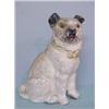 Image 1 : CHALK SEATED DOG. White with a short, curly tail and black painted ears and muzzle and yellow eye…