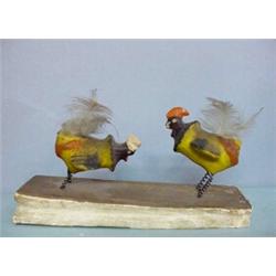 PIPSQUEAK. Two papier-mache fighting cocks with feather tails and spring legs. Handpainted in yel…