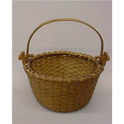 WOVEN SPLINT BASKET WITH SWING HANDLE. Mellow natural patina. Round with tapering sides and a cen…