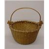Image 1 : WOVEN SPLINT BASKET WITH SWING HANDLE. Mellow natural patina. Round with tapering sides and a cen…