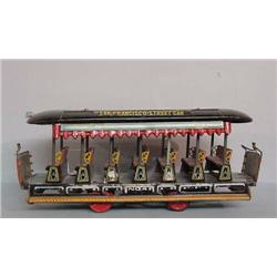 THREE TIN TOYS. Chromolithographed "San Francisco Streetcar" (pictured). Black, red, blue, and ye…