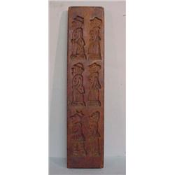TWO WOODEN COOKIE BOARDS. Three carved couples with exaggerated features. Of the men, one wears a…