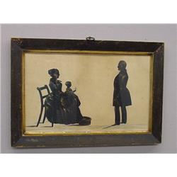 DOUBLE SILHOUETTE. Cutout portraits of three family members. A woman seated in a chair holding he…