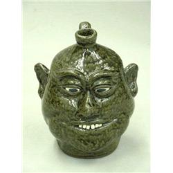 "LANIER MEADERS" GROTESQUE JUG. Redware with green ash glaze. Round cheeks with unglazed white cl…