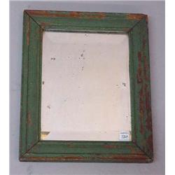 MIRROR. Beveled edge mirror in a wooden molded frame with original worn and alligatored medium gr…