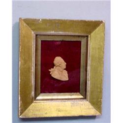 WAX PORTRAIT MEDALLION. Profile of a man wearing a pigtailed wig and colonial era coat and scarf.…