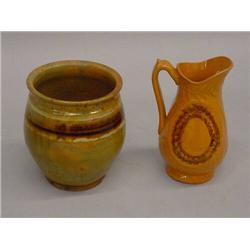 TWO PIECES OF REDWARE. Molded pitcher with raised foliage and oval with brown sponging. Applied h…