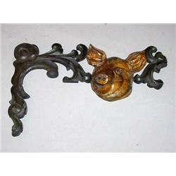 DECORATED CARVED WOODEN ORNAMENT. Happy hog face with gold paint, surrounded by green scrolled le…