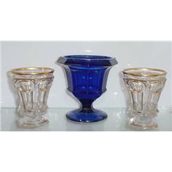THREE PIECES OF FLINT GLASS. Pictured is one of a pair of spill holders with gilt trim along the …