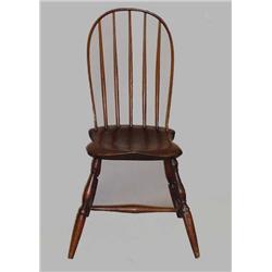 BOWBACK WINDSOR SIDE CHAIR. Dark refinishing. Baluster and ring turned legs with an "H" shaped st…