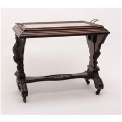 Turn-of-the-century carved patriotic wood and  glass table with wooden rollers, approx. 28” long  x 