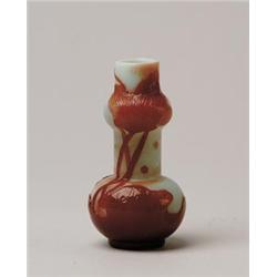 SMALL GALLE VASE.  Burnt orange glass over oyster white.  Fire polished cameo decoration of leaves. 