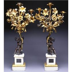 PAIR OF FRENCH PATINATED AND GILT-BRONZE AND MARBLE FIVE-LIGHT CANDELABRA, each formed as an arra...