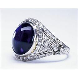 PLATINUM FILIGREE RING, bezel set with an oval synthetic sapphire cabochon in a mount decorated w...