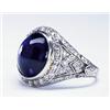 Image 1 : PLATINUM FILIGREE RING, bezel set with an oval synthetic sapphire cabochon in a mount decorated w...