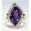 Image 1 : 14K YELLOW GOLD RING, bezel set with an unusual ellipsoid-shaped fancy cut amethyst encircled by...