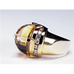 14K YELLOW GOLD RING, set with an unusual saddle-shaped fancy cut citrine flanked by 14 channel s...