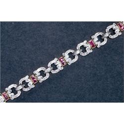 14K YELLOW AND WHITE GOLD FILIGREE BRACELET, set with 22 French cut rubies (approx. 0.85ct. total...