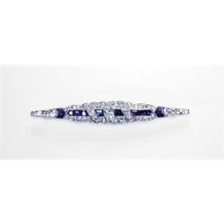 PLATINUM FILIGREE BARPIN, bezel set with a central oval old cut diamond (approx. 0.29ct.) and dec...