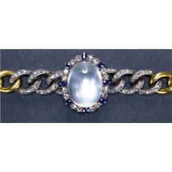 FRENCH 18K YELLOW GOLD AND SILVER BRACELET, formed of a central medallion set with a large moonst...