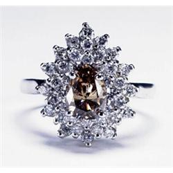 PLATINUM COCKTAIL RING, set with a pear cut "champagne" diamond (approx. 0.90ct.) surrounded by 3...