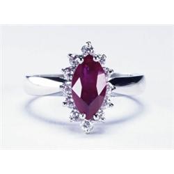 PLATINUM RING, set with a marquis cut ruby (approx. 1.15ct.) encircled by 12 brilliant cut diamon...