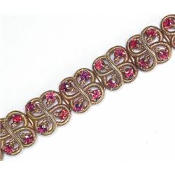 18K YELLOW GOLD BRACELET, formed of stylized square links and set with 56 full cut rubies (approx...