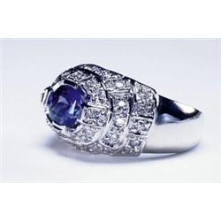 14K WHITE GOLD COCKTAIL RING, set with an oval cut sapphire (approx. 2.48ct.) in a mount decorate...
