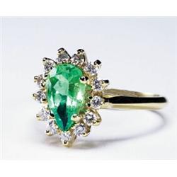 18K YELLOW GOLD RING, set with a pear cut emerald (approx. 1.10ct.) encircled by 13 brilliant cut...