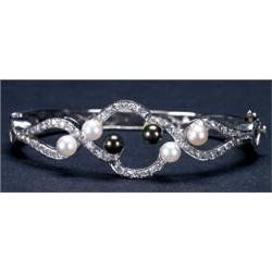 14K WHITE GOLD OPENWORK HINGED BANGLE, set with 58 single cut diamonds (approx. 1.00ct. total wei...