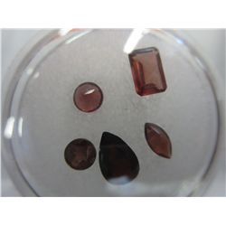 Gem jar filled with assorted garnet gemstones