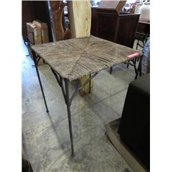 Metal patio table with woven rattan top