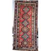 Image 1 : A GENJE LONG RUG, central Caucasus, c.1910, the pale red field containing six latchhooked meddall...