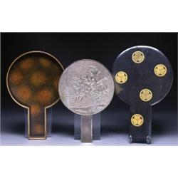 A BRONZE MIRROR AND CASE, the mirror well worked with flowers on a stippled ground, the case work...