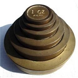 England, c. 1850, a set of six stacked brass weights marked AVERY Ltd. The smallest weight is 1...