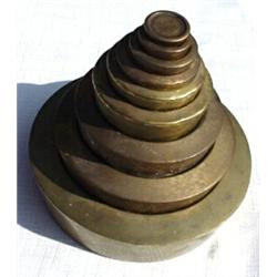 England, c. 1850, a set of nine stacked brass weights. The smallest1/4 oz weight is marked AVERY...