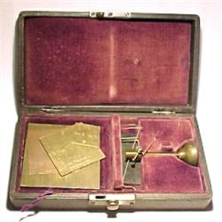 England, c. 1900, a yarn scale contained in a leather covered box and presented in a red velvet...