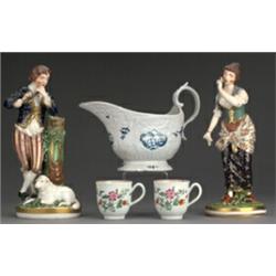 Two 18th Century English porcelain coffee cups having moulded scroll handles, exteriors with poly...