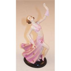 Art Deco porcelain figure of a lady dancing with outstretched arms wearing pink dress standing on...