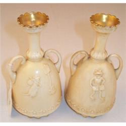 Pair of two handled Doulton vases, the flared necks with gilt highlights, the mallet shaped ivory...