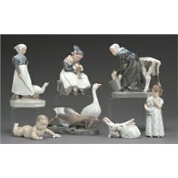 Royal Copenhagen porcelain group of a milkmaid feeding a calf, printed and painted marks no 779,...