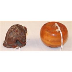 Carved boxwood netsuke depicting a fierce temple lion with a ball, base signed, 3.5cms high Est.:...