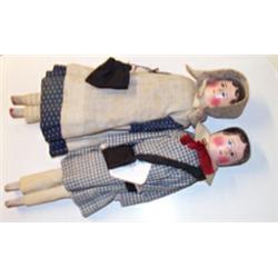 Pair of mid 19th Century wooden peg dolls having painted features, jointed wooden bodies and orig...